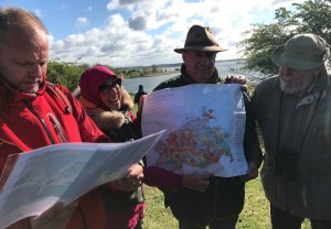 People on a field trip, holding a map